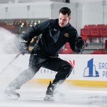 A kid practicing with coach Nick Orlando at Hockey Etcetera