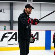 Daniel Portelance coaching and pointing his stick to instruct a player