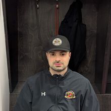 Daniel Portelance coaching and pointing his stick to instruct a player