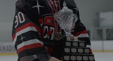 A close up photo of a goalie holding the trophy at the Hockey Etcetera Coast to Coast showdown in 2023