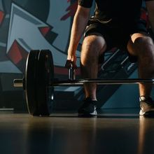 Athlete being coached about form while deadlifting at Junxion Performance