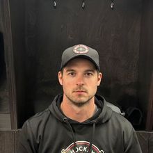 Daniel Portelance coaching and pointing his stick to instruct a player